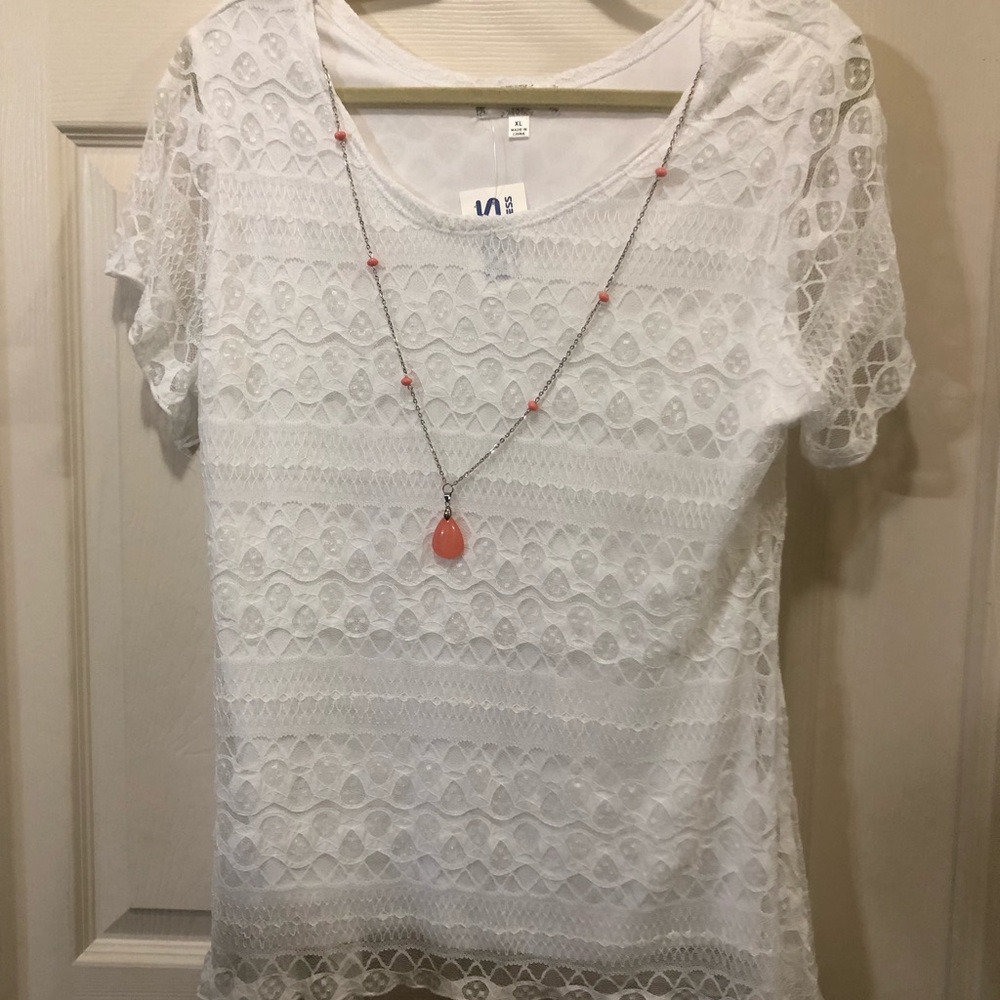 White shirt with coral necklace